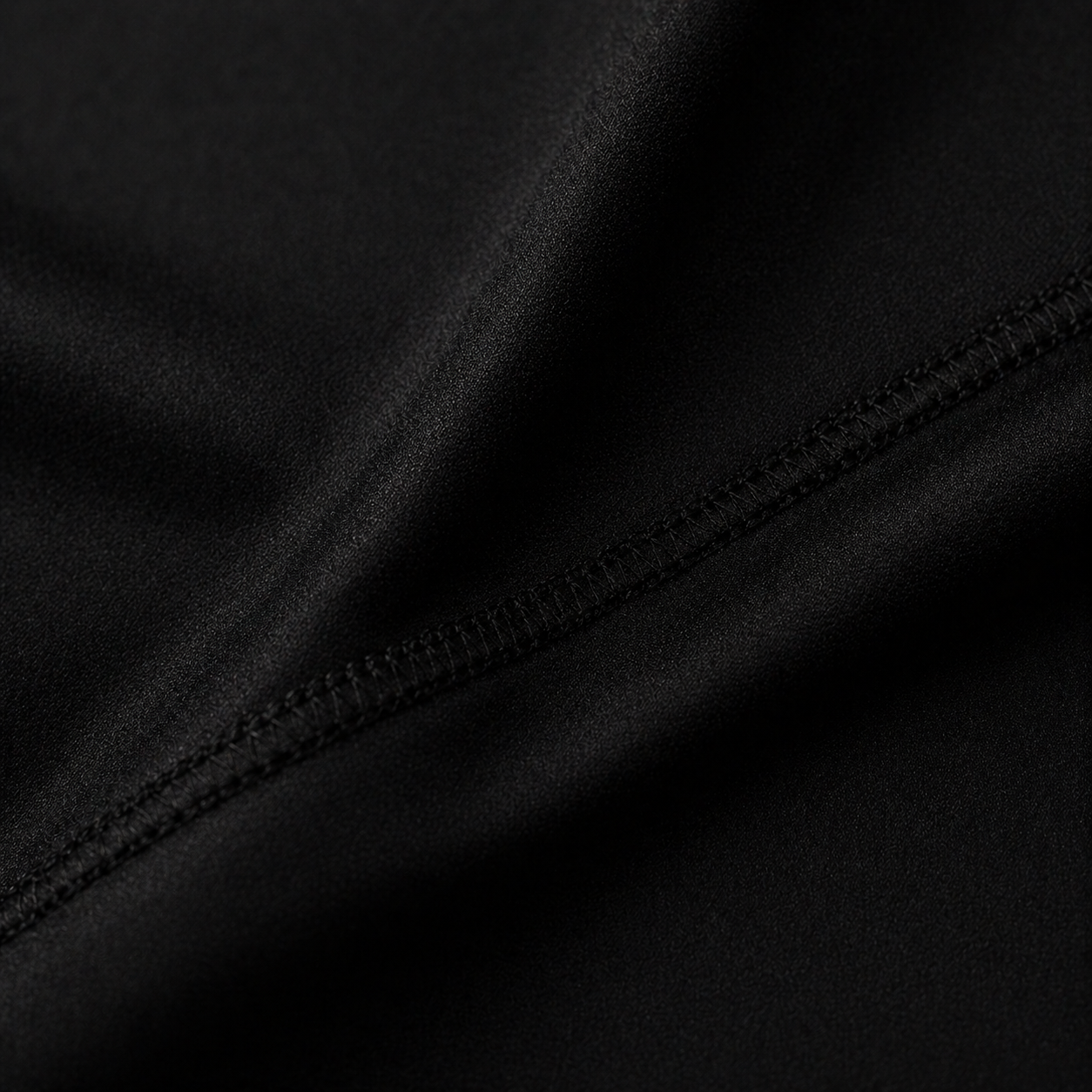 Black Project Ippon Rash Guard, Blackout Edition, shown on a model, highlighting its sleek design and athletic fit.